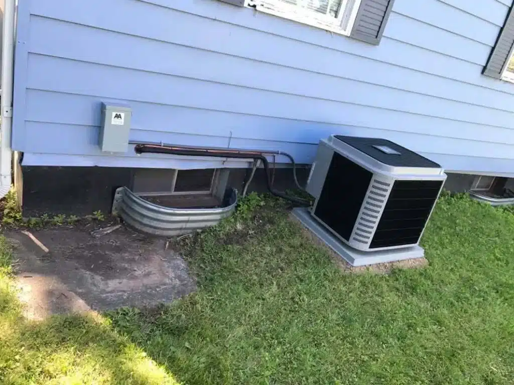 New AC condenser installed beside a home