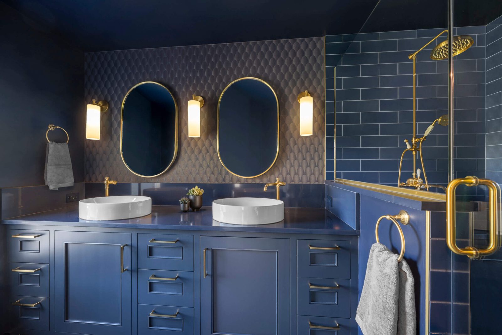 Navy double vanity with brass fixtures