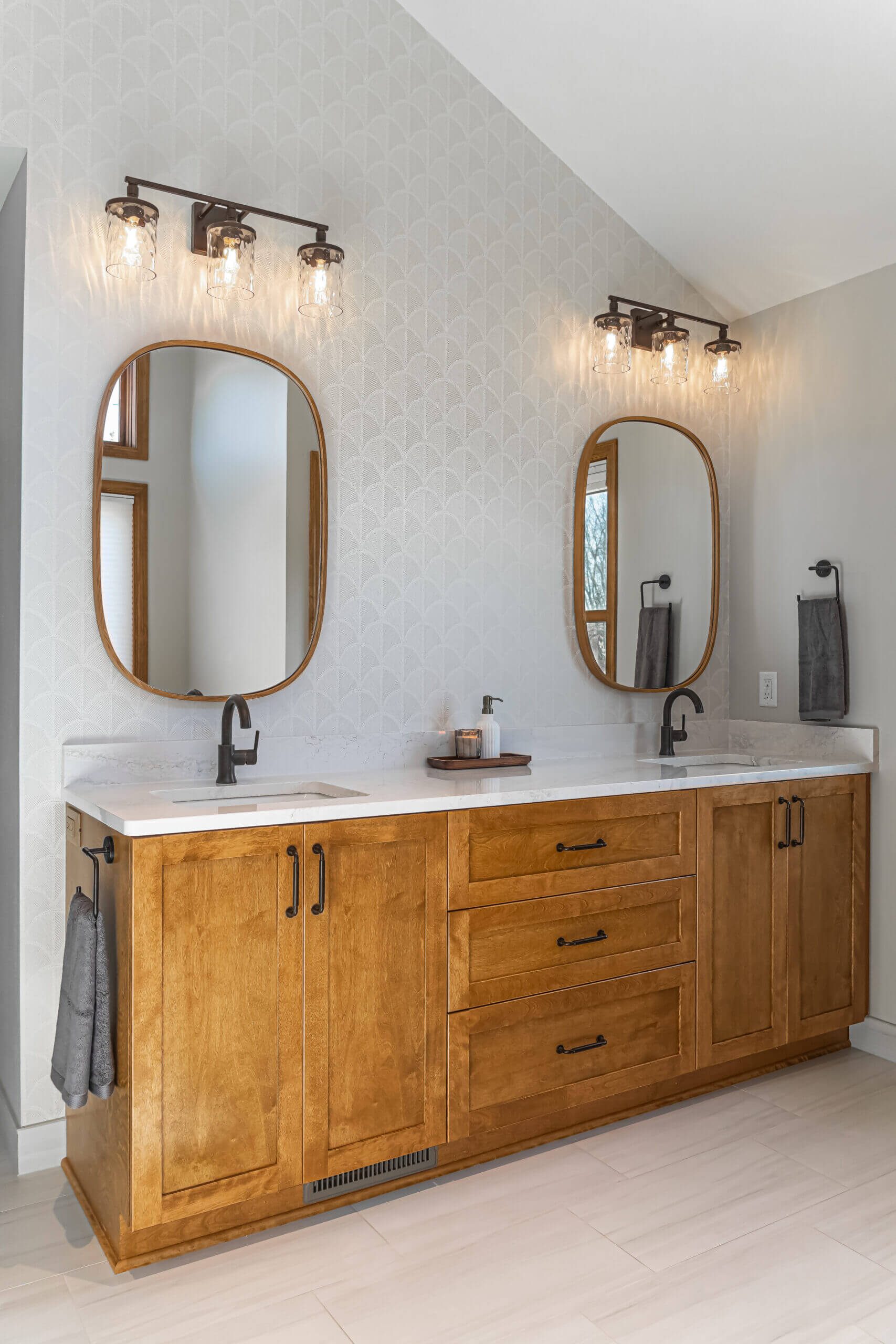 Bathroom remodel with double vanity and wood cabinetry
