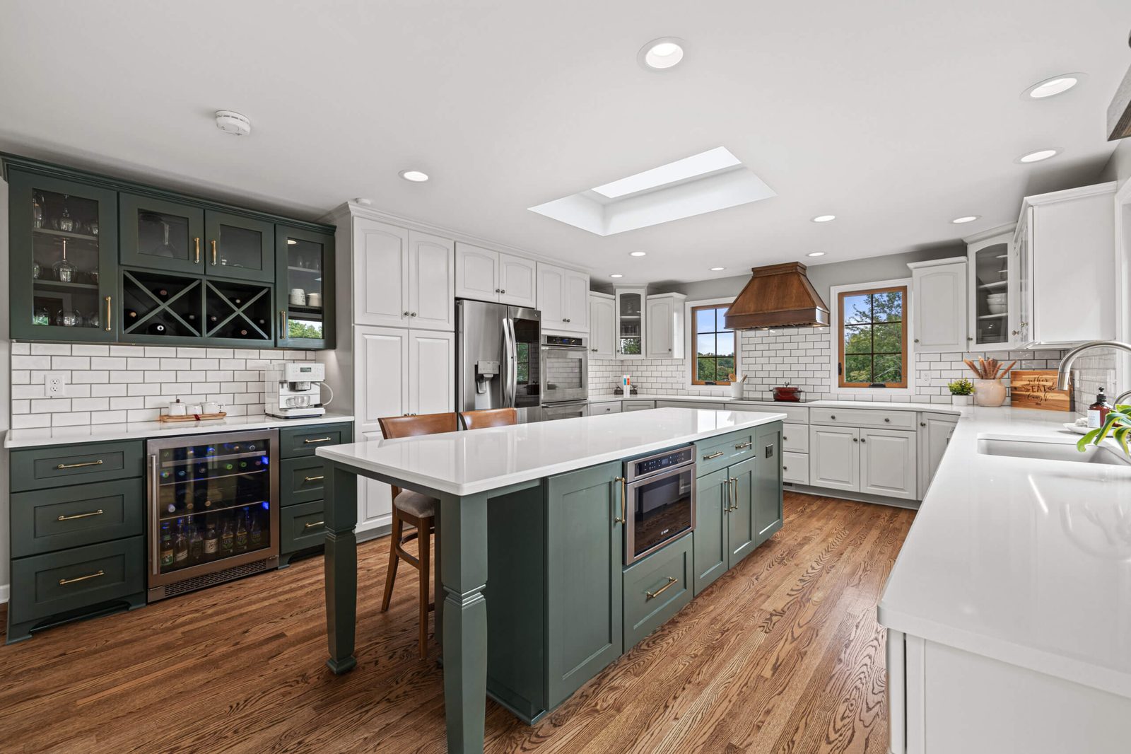 Kitchen remodel with green island and skylights