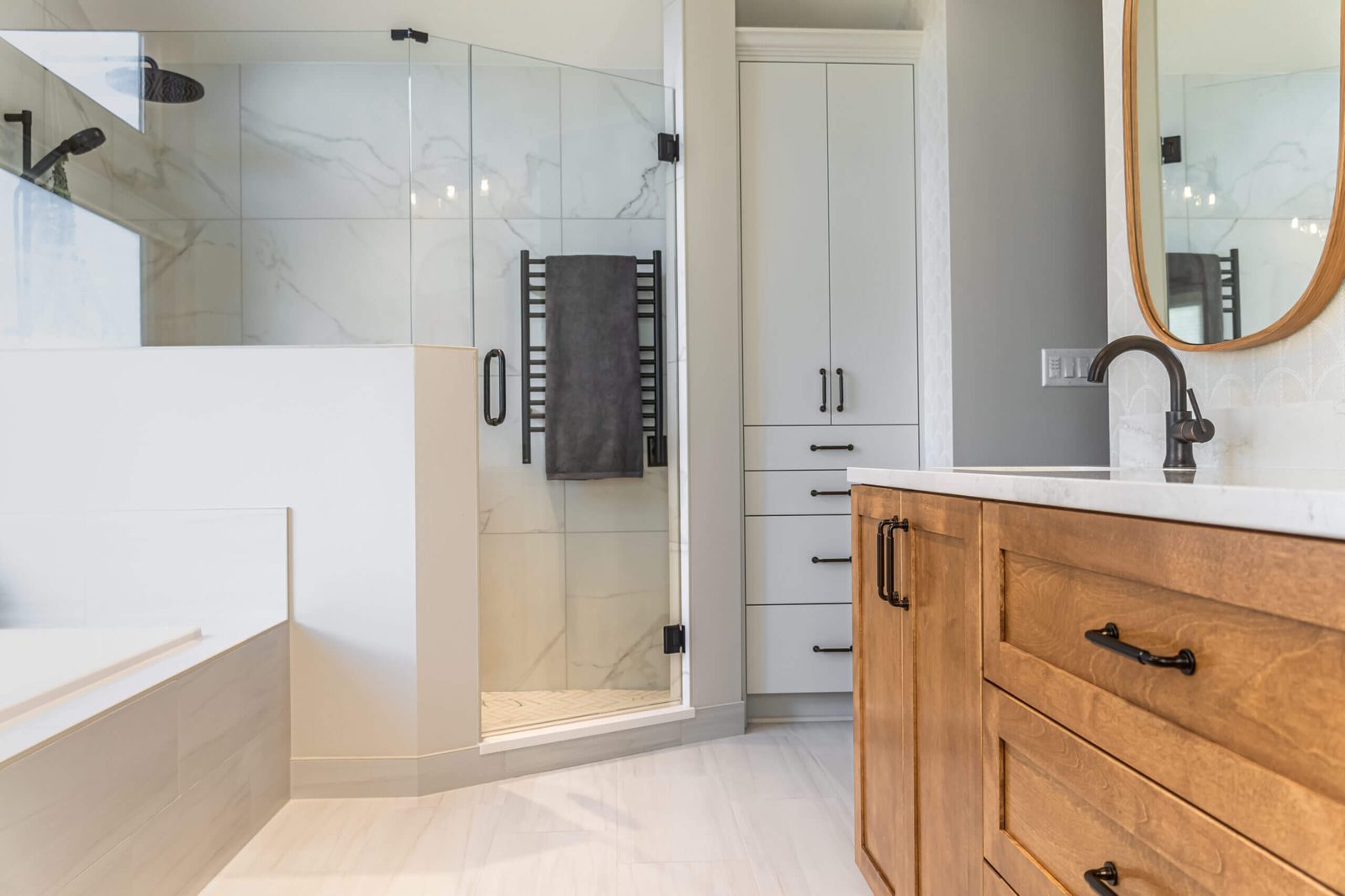 Bathroom remodel with walk-in shower and wood vanity