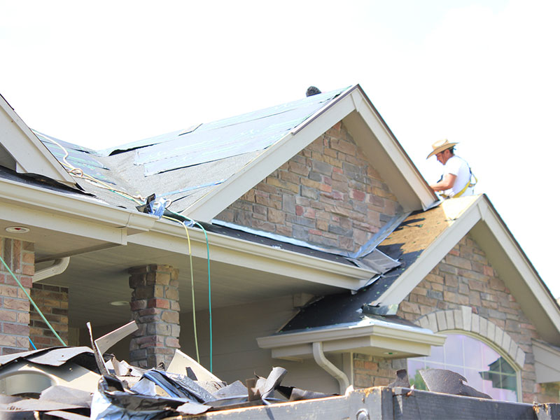 Anderson Roofing crew tearing off an old roof in Omaha