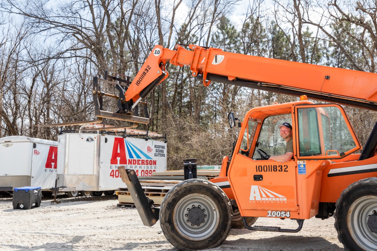 Anderson Roofing equipment loading shingles onto a roof