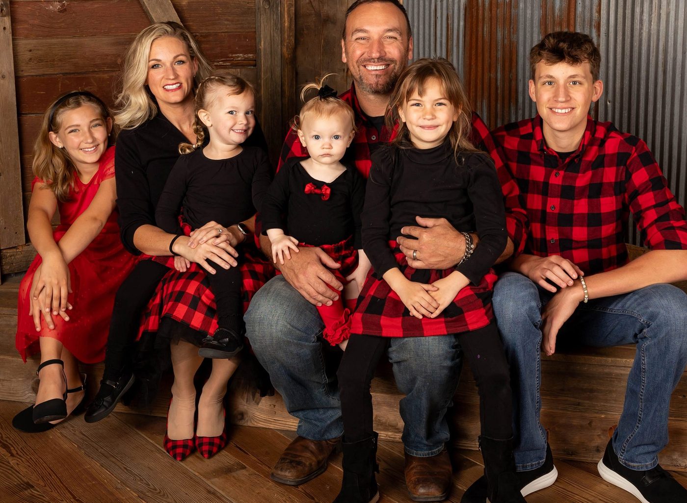 Brad and Lallenia Birge with their five kids in matching buffalo plaid