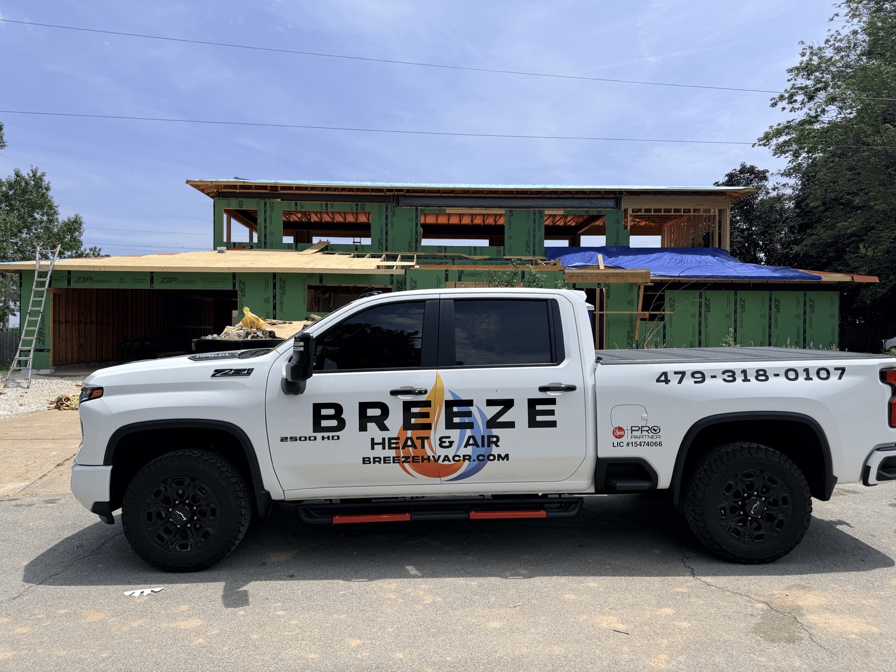 Breeze Heat and Air truck at a new home construction site in Northwest Arkansas