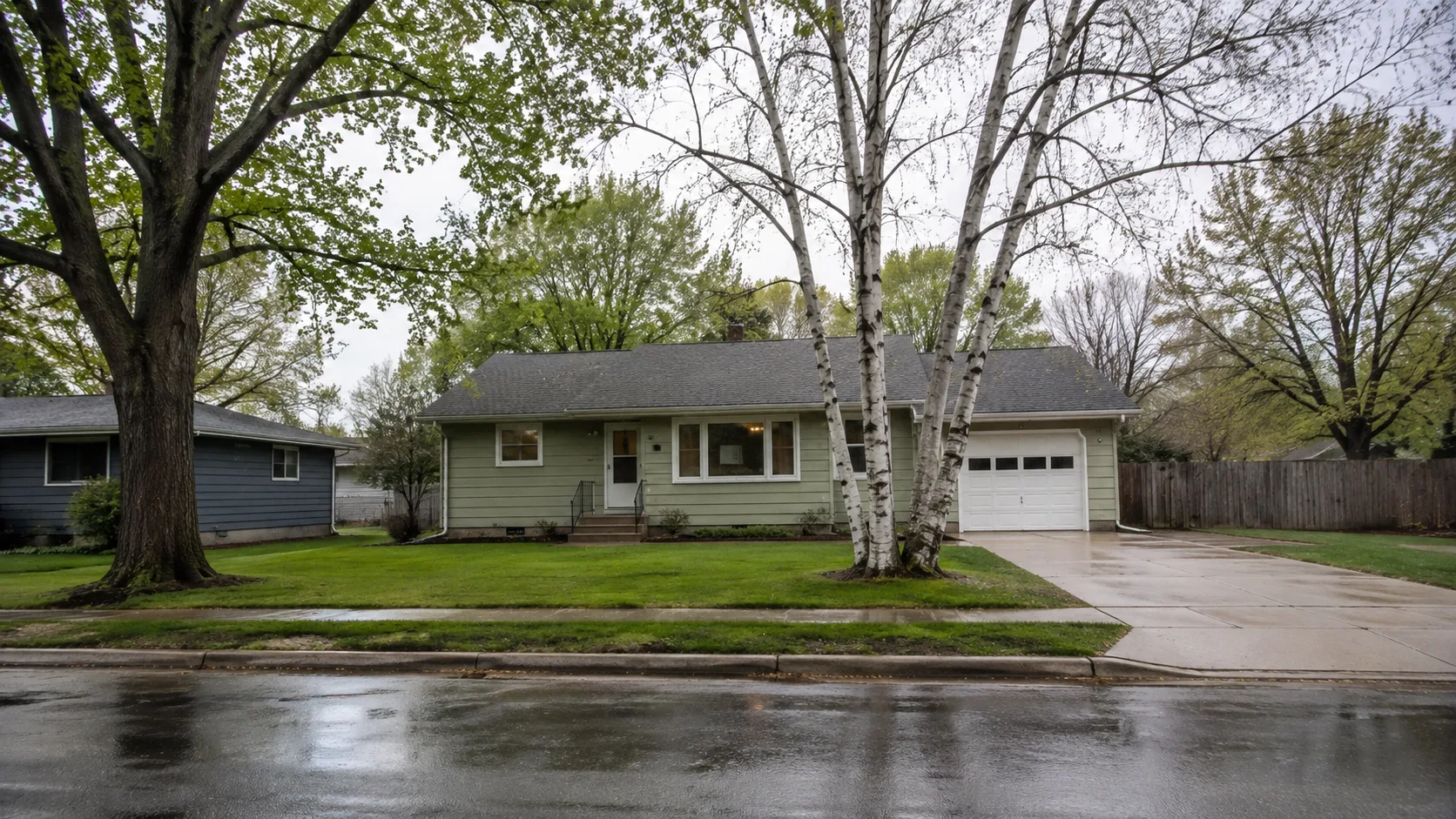 Modest ranch home on a level Superior neighborhood street after spring rain