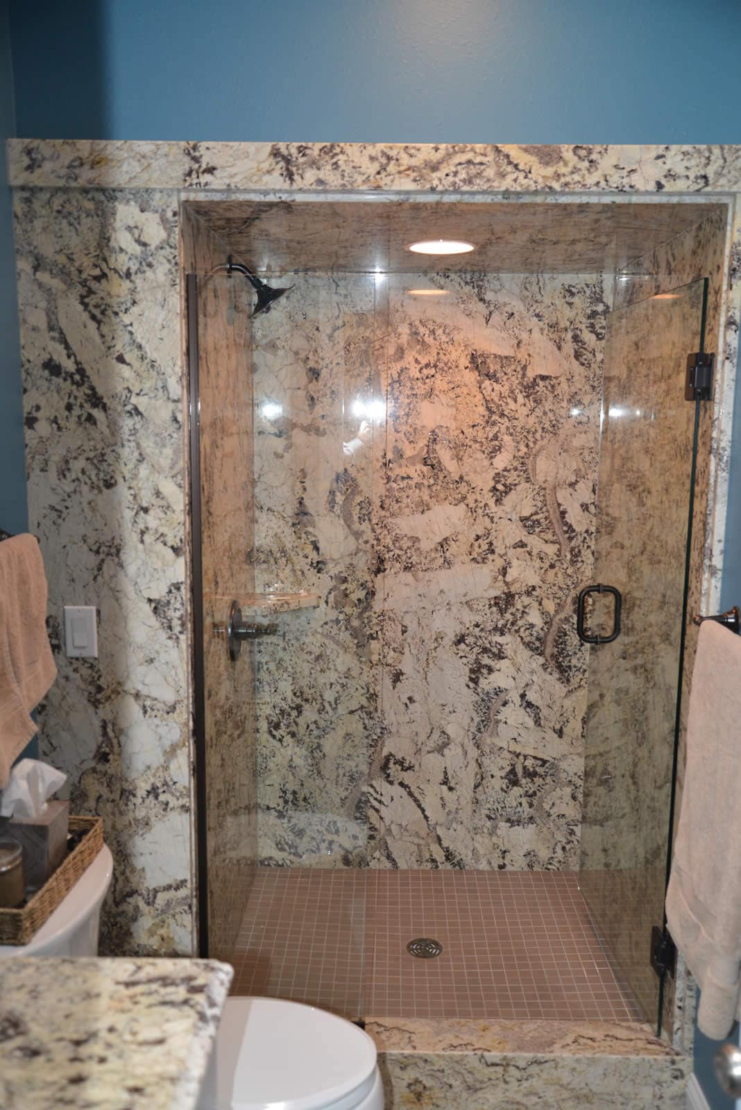 Floor to ceiling stone shower surround