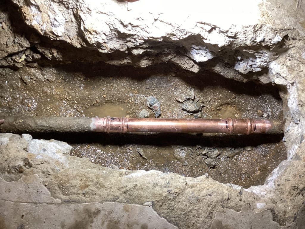 A copper repair section soldered into an open slab trench on one of our San Diego jobs