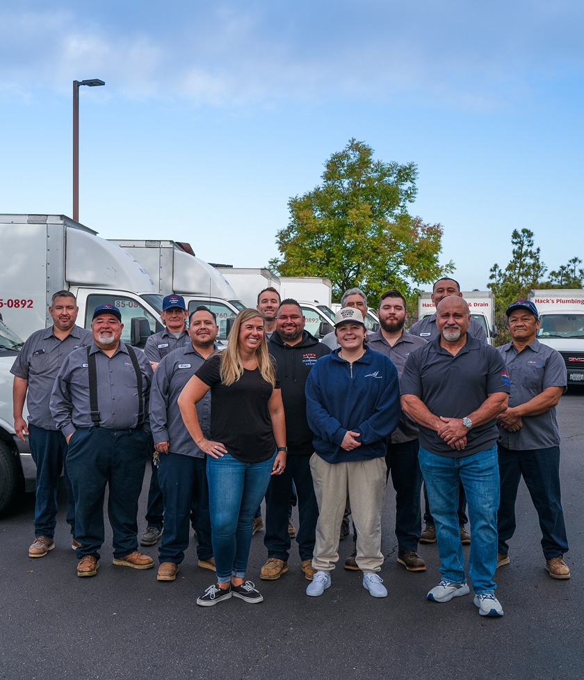 The Hack's Plumbing and Drain team in front of their service trucks