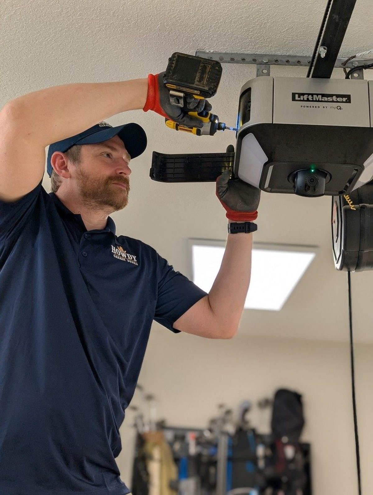 Howdy Garage Doors technician installing a LiftMaster garage door opener