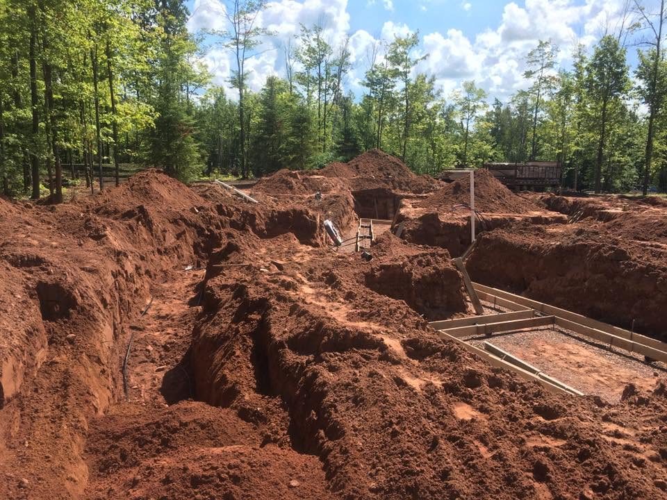 Foundation excavation in progress with footings staked
