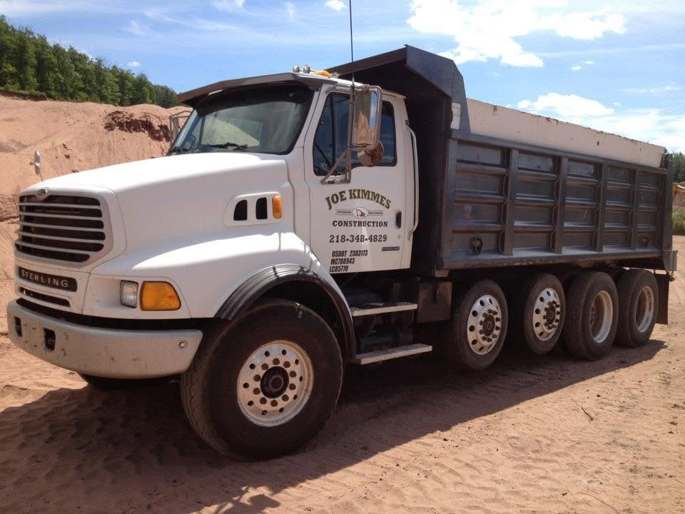 Joe Kimmes Construction dump truck at a material pile