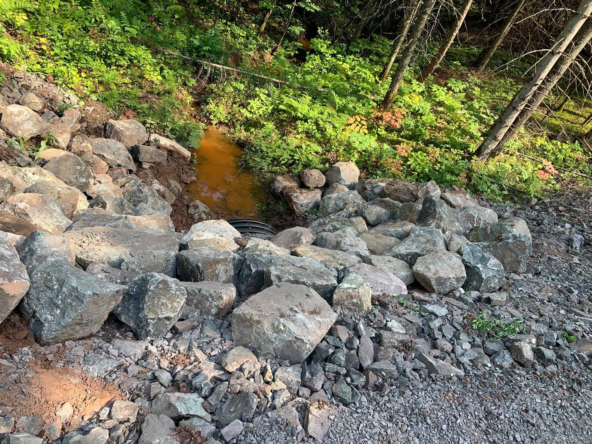 Rip rap rock placed along a shoreline creek