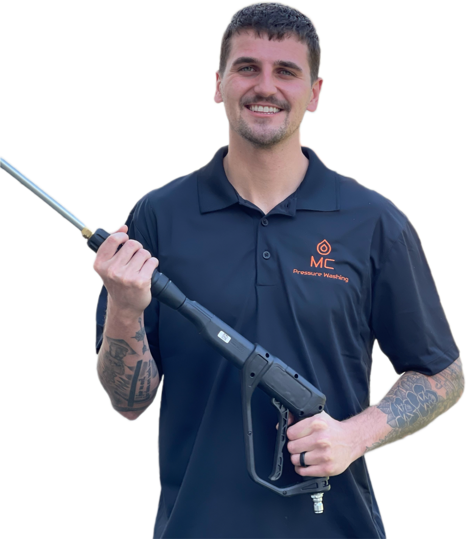 MC Pressure Washing co-owner holding a pressure washing wand
