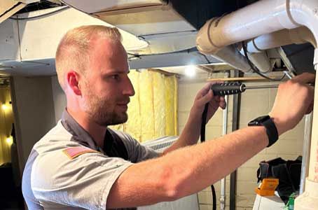 Plumbing Today technician working on overhead supply lines