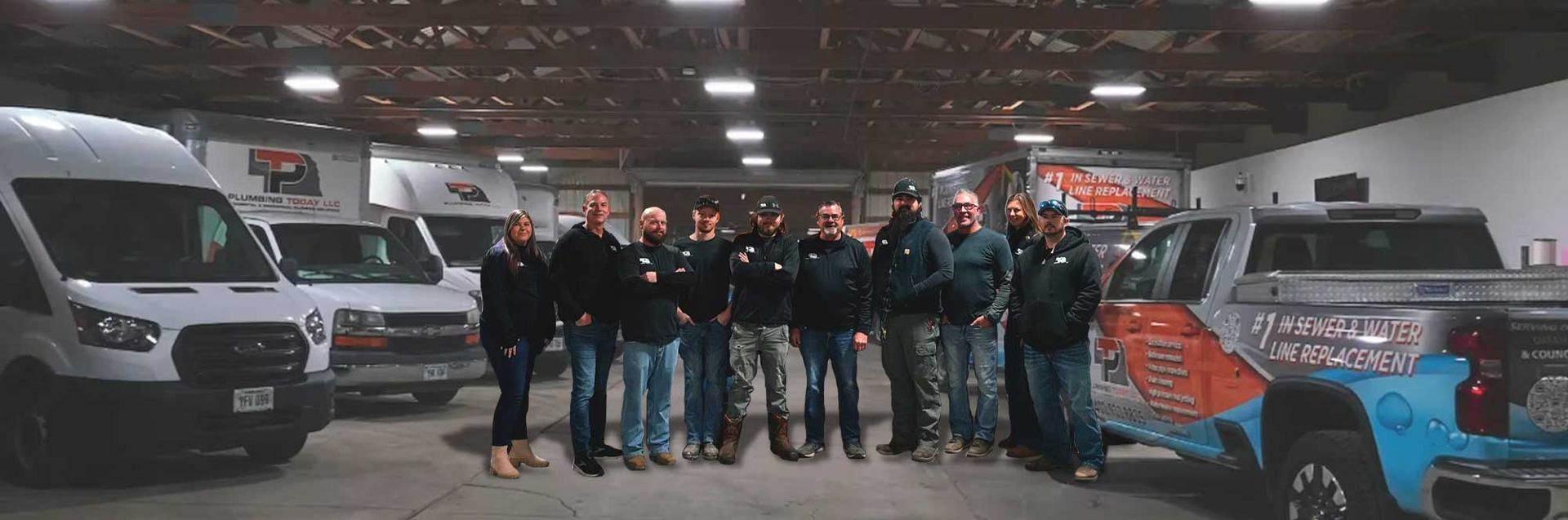 The Plumbing Today HVAC crew standing with their service fleet