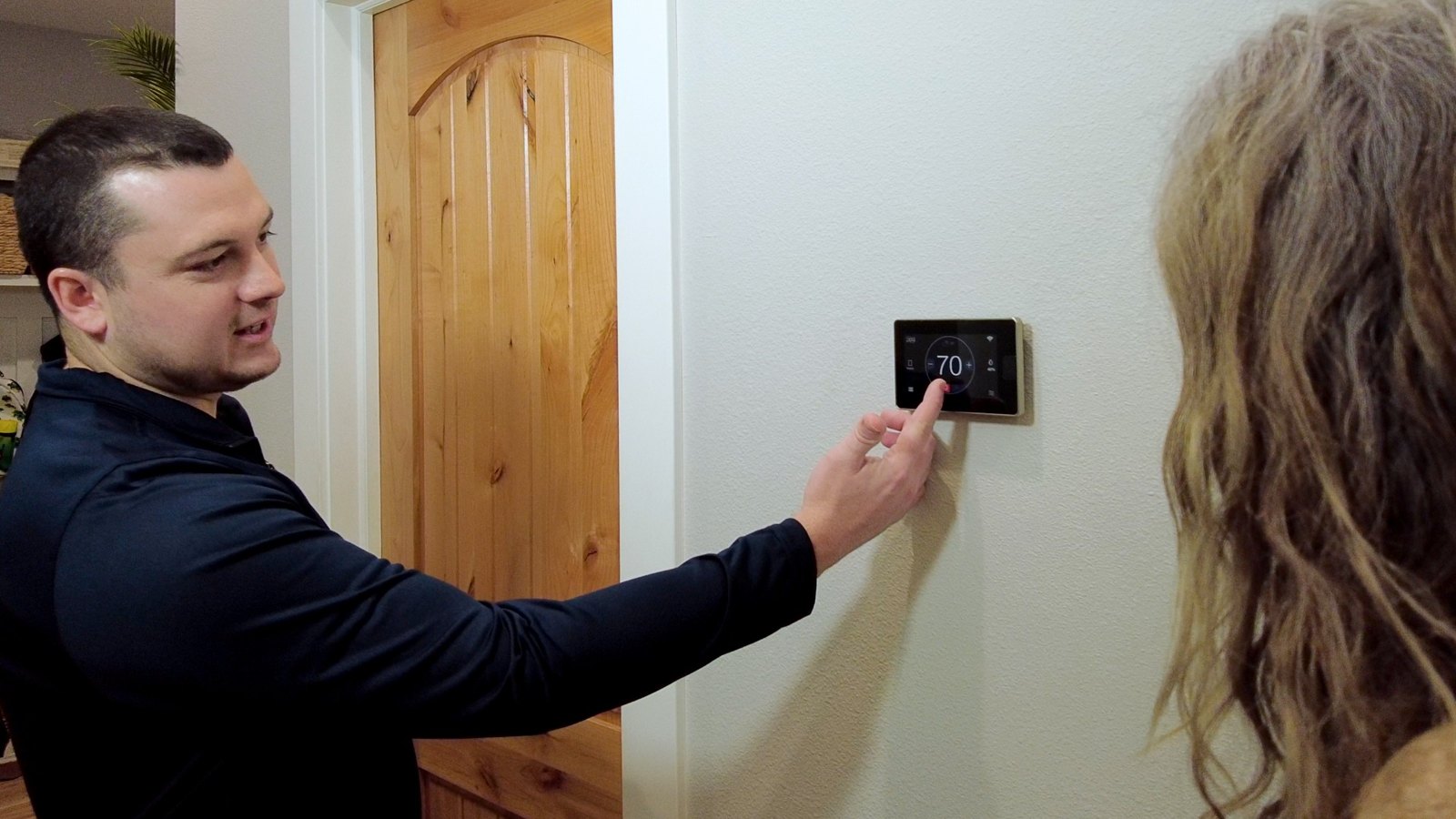 River City technicians helping an Omaha homeowner with a smart thermostat