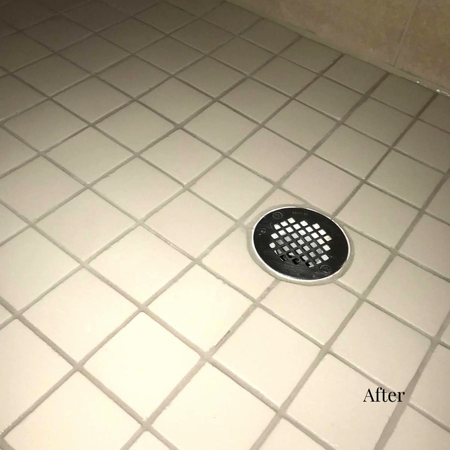 Restored white grout lines on a hotel bathroom tile floor