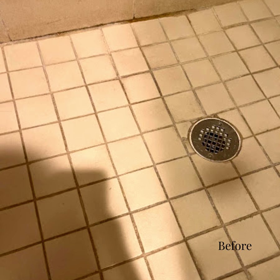 Stained tile and grout on a hotel shower floor
