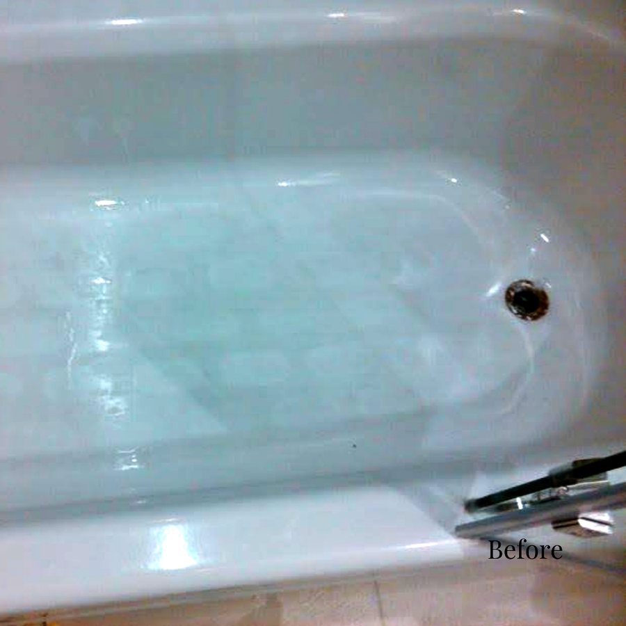 A hotel bathtub floor with a discolored, worn anti-slip pattern
