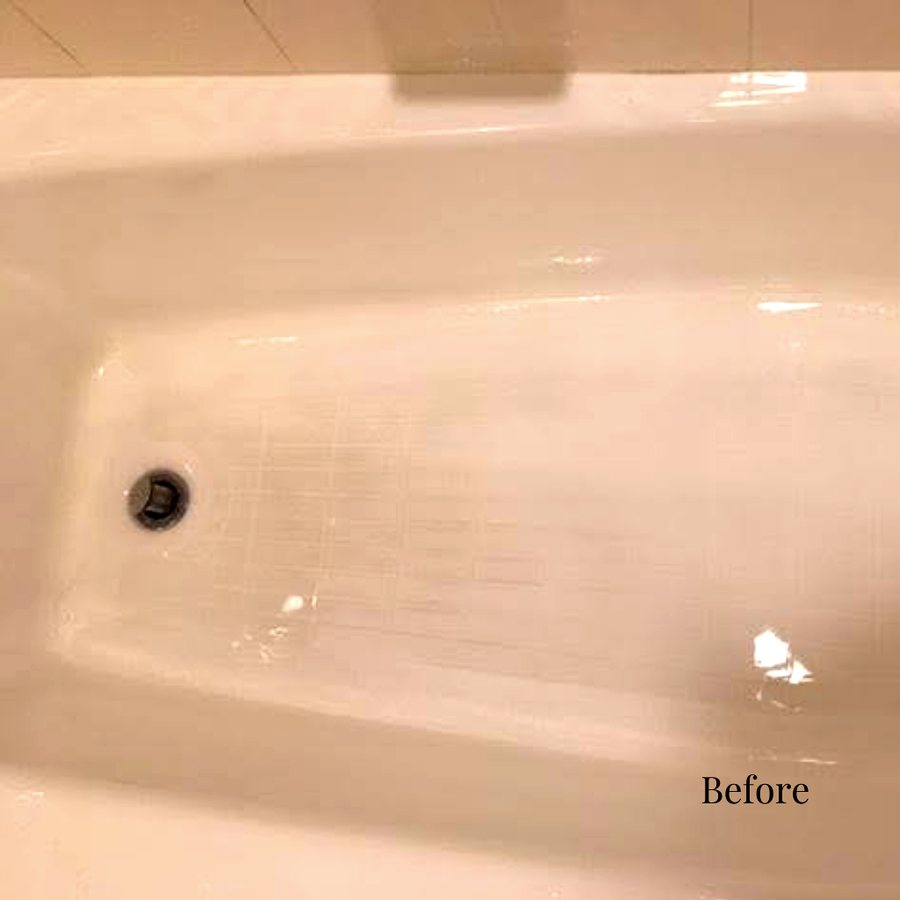 A discolored beige hotel bathtub before refinishing