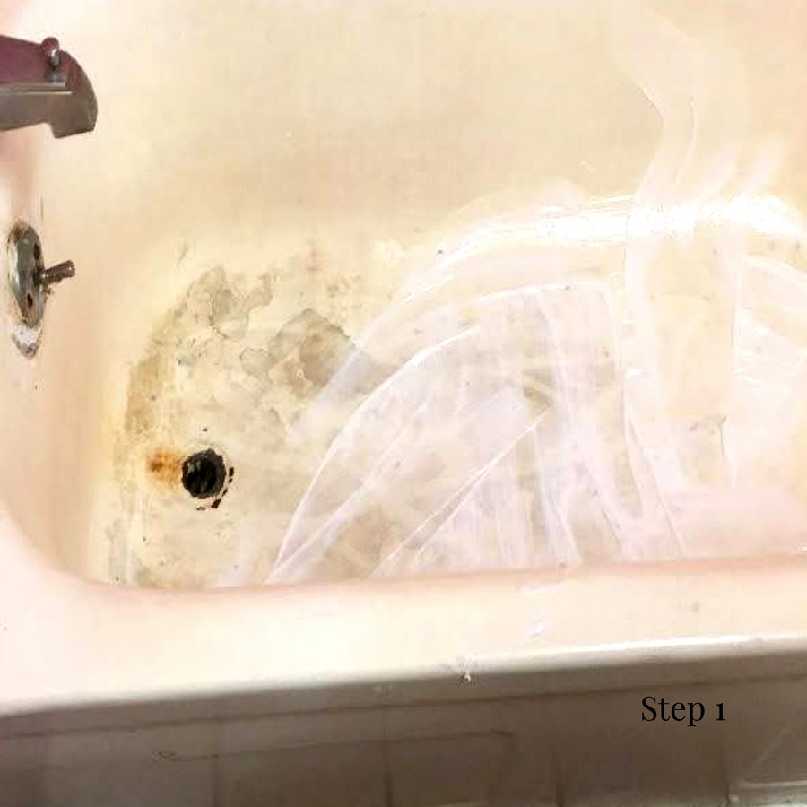 A stained hotel bathtub masked off before work begins