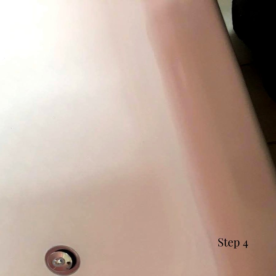 Primer and top coats being applied to the tub