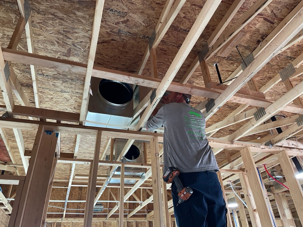 Savvy Systems tech installing ductwork in new construction