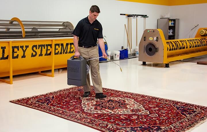 Certified technician cleaning an oriental rug
