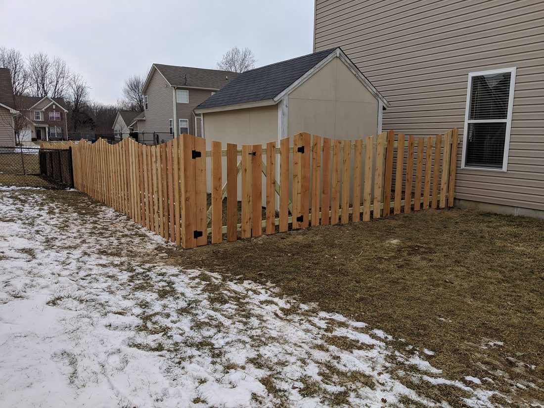 Cedar scalloped picket fence with gate installed by Stony Creek Fence Co