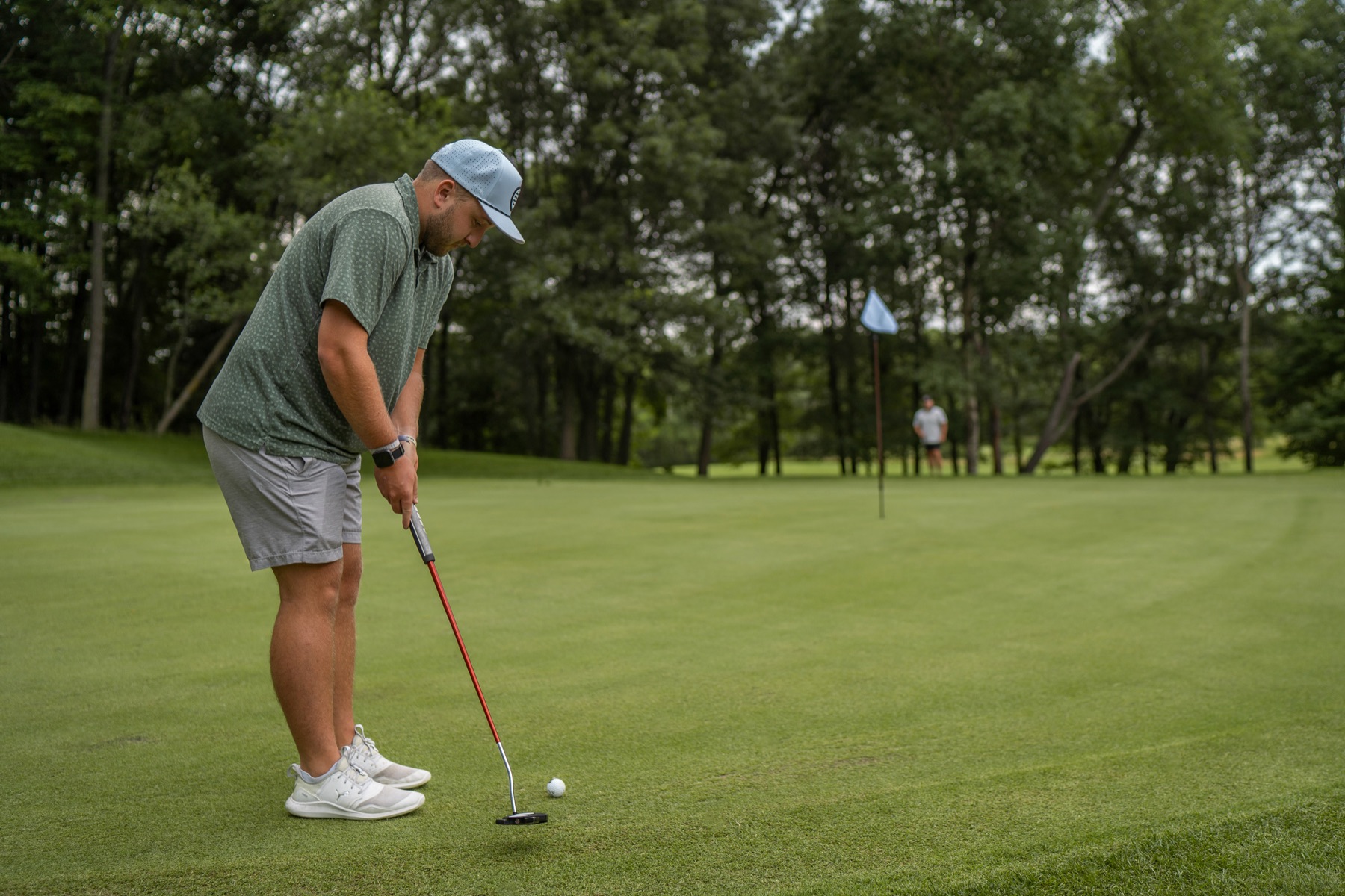 A golfer putting on a Tanglewood green