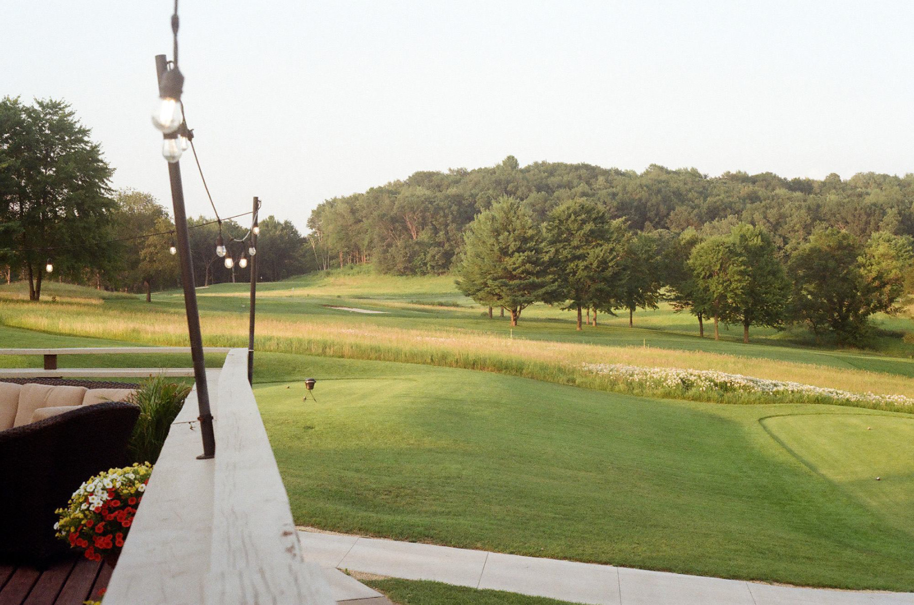 Wood & Vine patio overlooking the course at golden hour