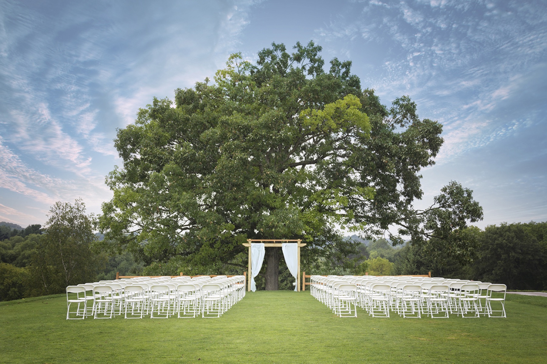 Wedding ceremony setup under the oak at Tanglewood Greens