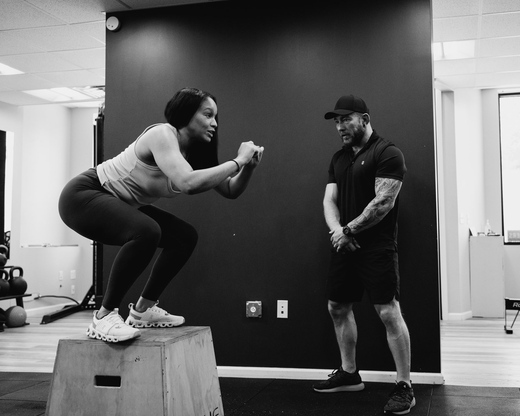 A client mid box jump with Tom watching the landing