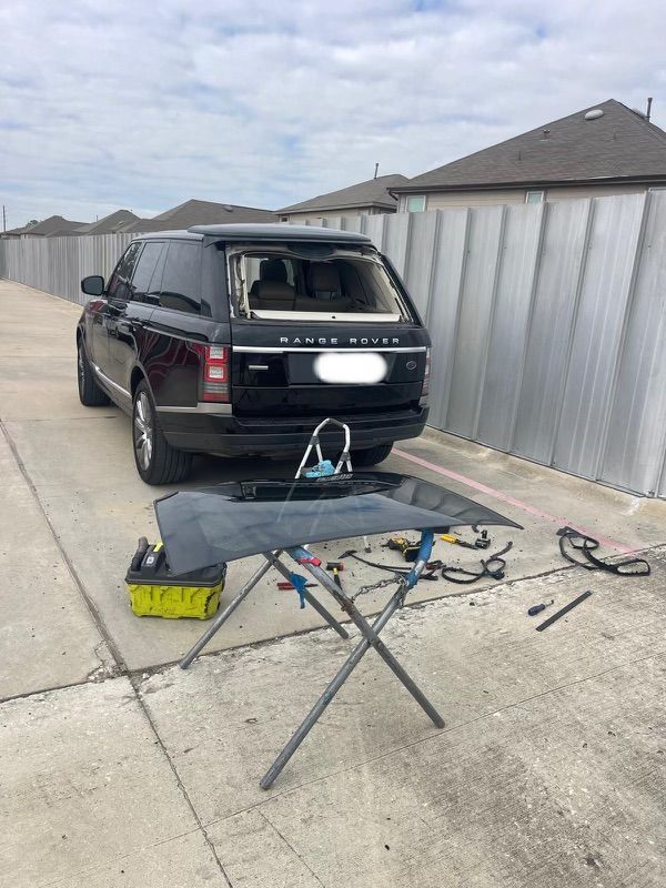Zico Auto Glass technician mid-install on a Range Rover back glass replacement